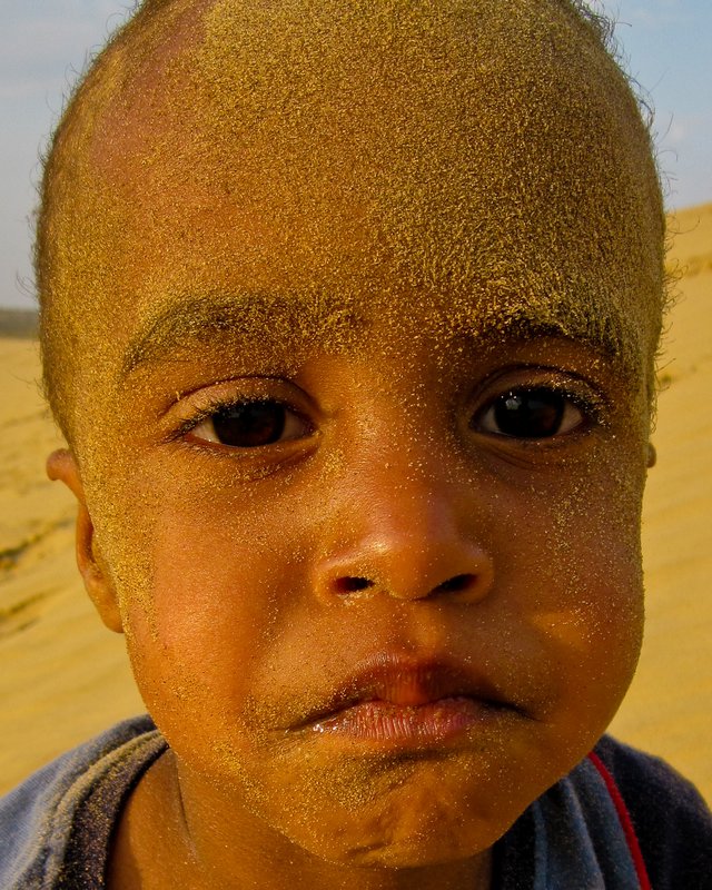 Luc covered in sand after rolling down the dunes near Jaisalmer
