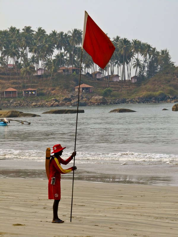Life guard putting up his flag on Palolem's beach