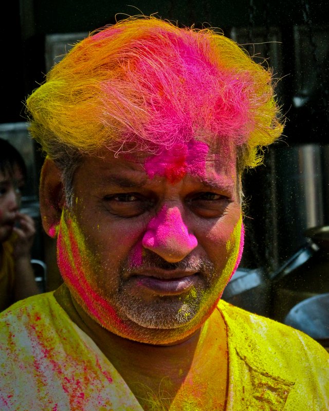 Pretty colourful man during the crazy Holi festival