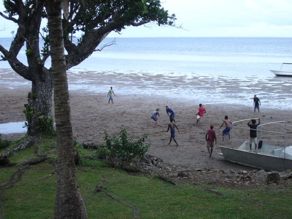locals playing rugby on beach outside our bure