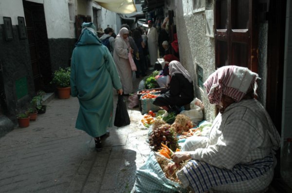 lot's of older ladies selling their fruits and veggies