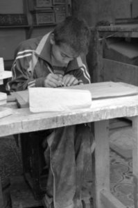 a kid working in a woodshop