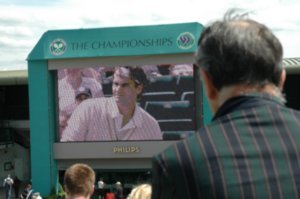the big screen where they were showing the Federer match