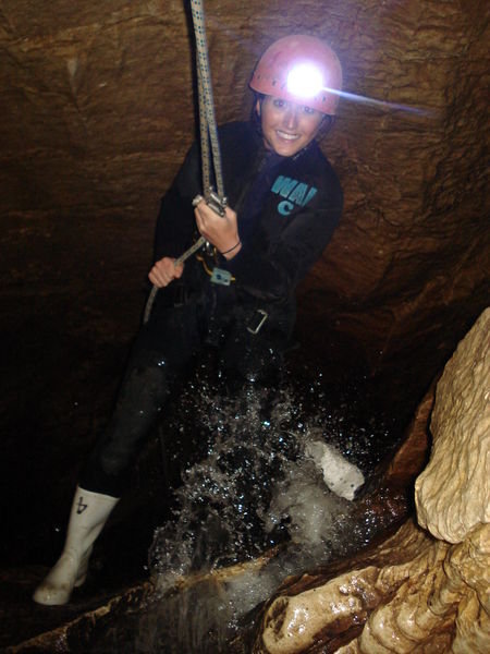 abseiling into a cave