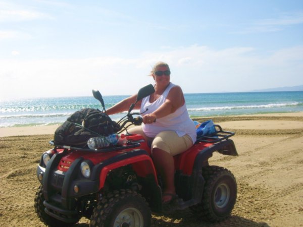 Lynne riding the ATV on a southern beach