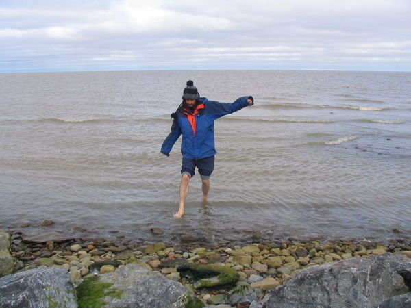 dipping his feet in the Arctic Ocean