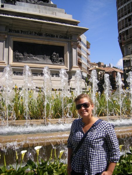 me in front of a pretty fountain in Granada