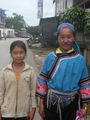 A Lolo Tribeswoman wearing traditional dress and her daughter. 
