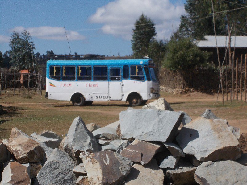 Our bus framed by a pile of rocks to be moved