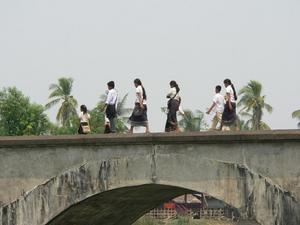 Schoolgirls crossing the bridge to Don Khong
