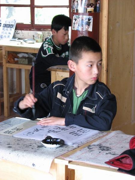 Boy in calligraphy class