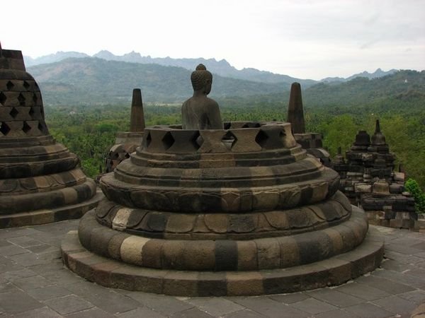 Buddha in broken stupa