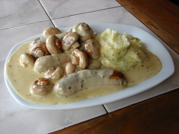 Bratwurst in a mushroom sauce with a dollop of mash