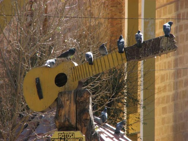 Guitar sign with birds
