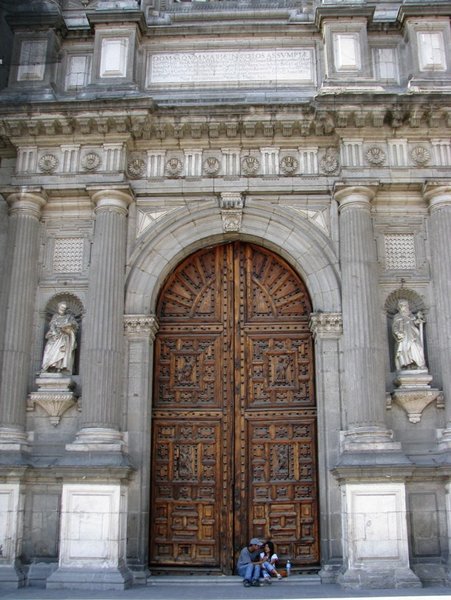 Young couple by cathedral doors