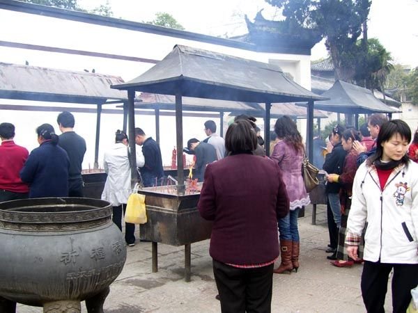 Burning incense at temple entrance
