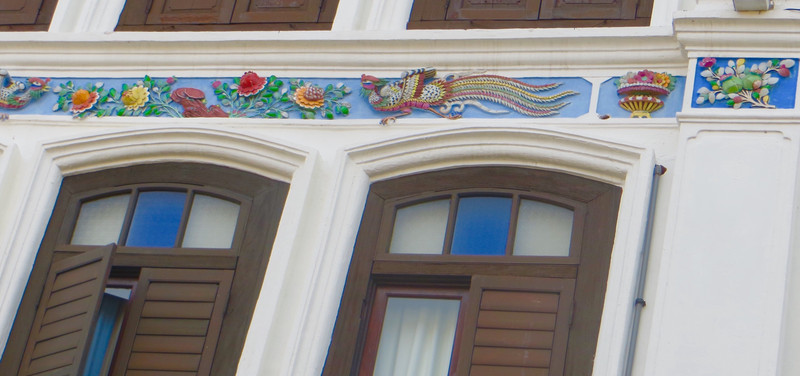 Colourful plaster decorations adorn many of the renovated shop houses.