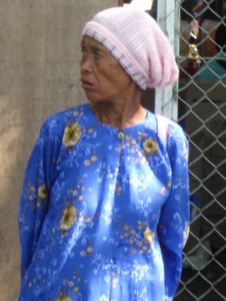 Elderly lady waiting at the markets