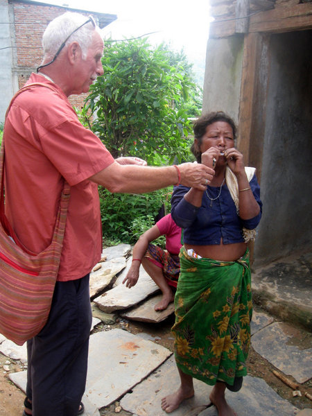 Jerry teaching local lady how to use cellophane to make a noise in Bandipur