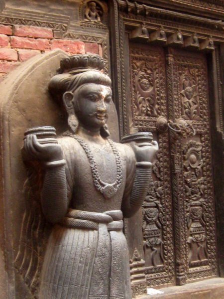 Statue and carved door in Durbar Square