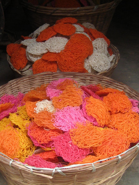 Brightly coloured dried noodles used during Puja
