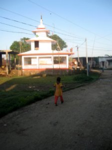 Girl going to the temple at sunrise