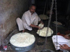 Weighing ghee for sale