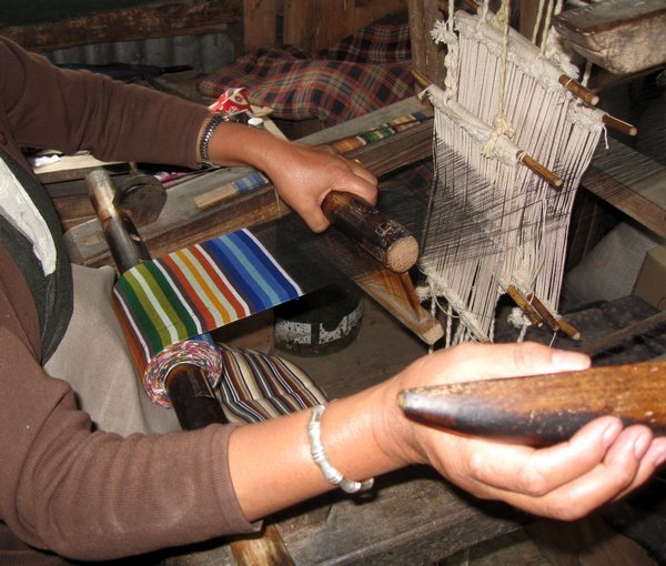 Weaving the traditional striped Tibetan apron patterns. 