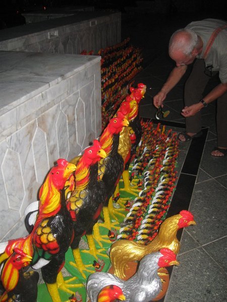 Rows of roosters given as offerings at a monument to King Naresuan