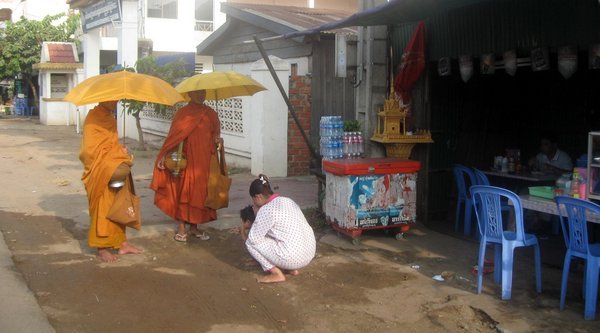 Giving alms to the monks in the morning