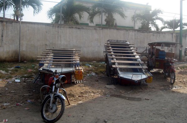 Local bus - trailer on motorcycle (with wooden planks for seats)