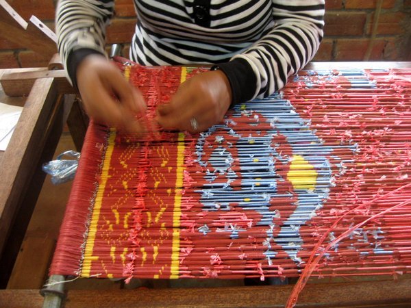 preparing the raw silk threads for dying into pattern shades before weaving
