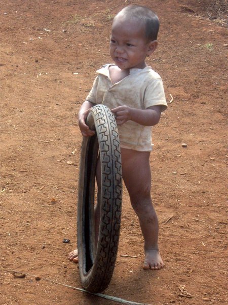This little kid had the cheekiest smile and was having a lot of fun rolling the tyre