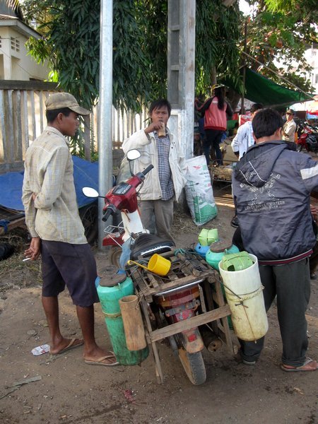 Selling rice wine (at breakfast) outside our hotel in Strung Treng
