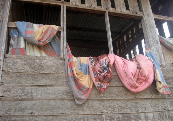 Bedding airing over village verandah 
