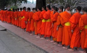 Morning procession of monks collecting alms in Luang Prabang