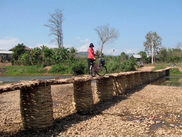 Linny crossing a bamboo bridge in Luang Nam Tha