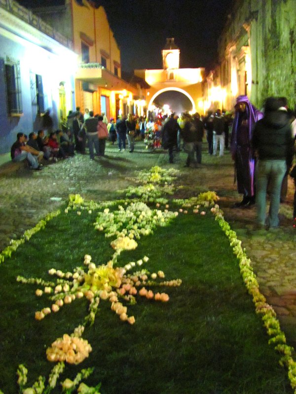 One of the flower and grass carpets laid on the streets during the procession