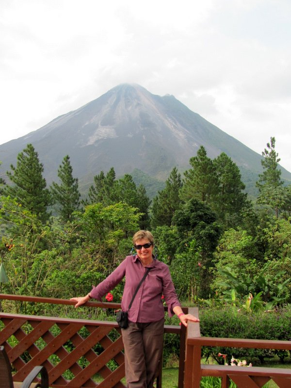 Linny on the balcony at the lodge, with Arenal volcano in the background