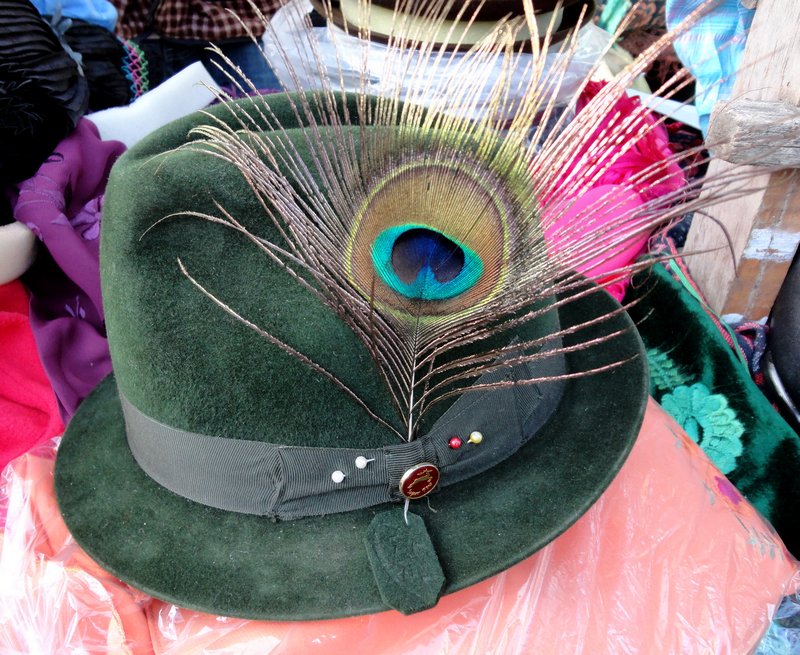 Green felt bowler hat with peacock feather trim as worn by Indigineous people in Quilatoa and Quito