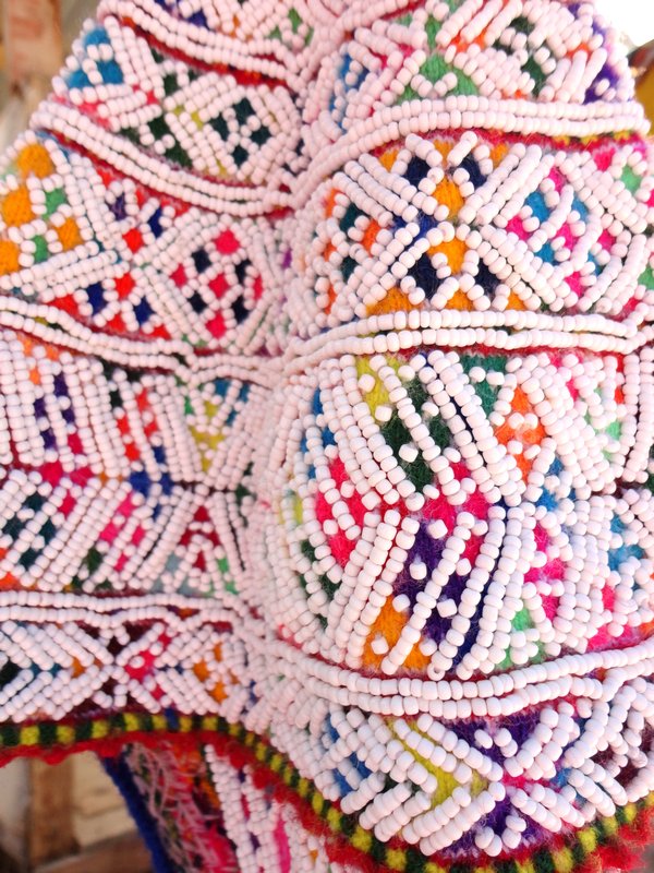 Traditional embroidered cap covered with white beads