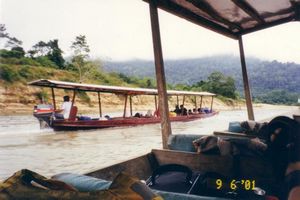 Long boats heading up the river towards Taman Negara National Park