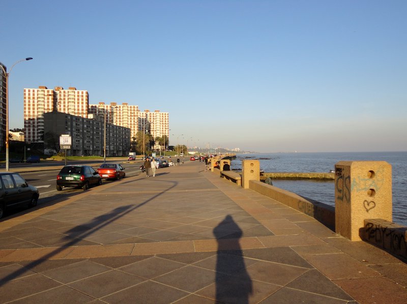 Shadow  on the wide rambla (footpath) along the edge of the Rio de la Plata and onwards to the Atlantic Ocean
