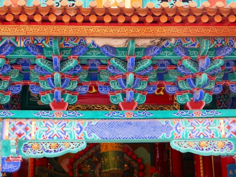 Colourful paintwork on roof line at the Yuantong Temple
