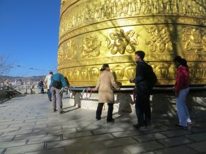 Trying to turn, unsuccessfully, the massive prayer wheel