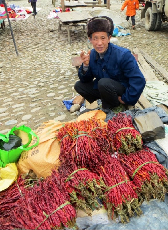 Old man selling dried chilli 