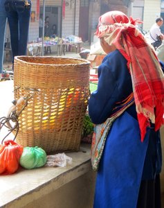 Packing her purchases into her back basket