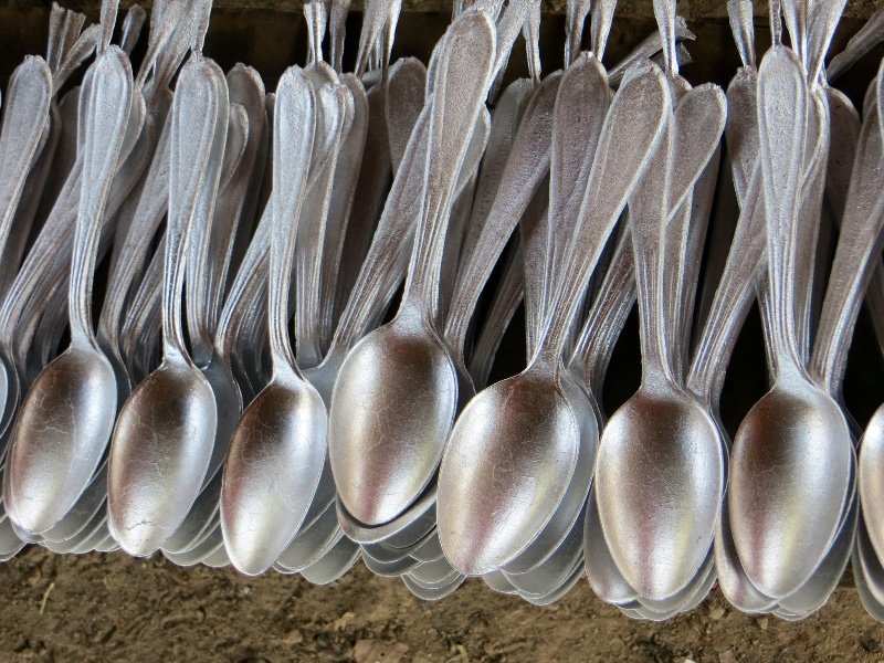 Aluminium spoons by the dozen - all made from melted down bomb casings