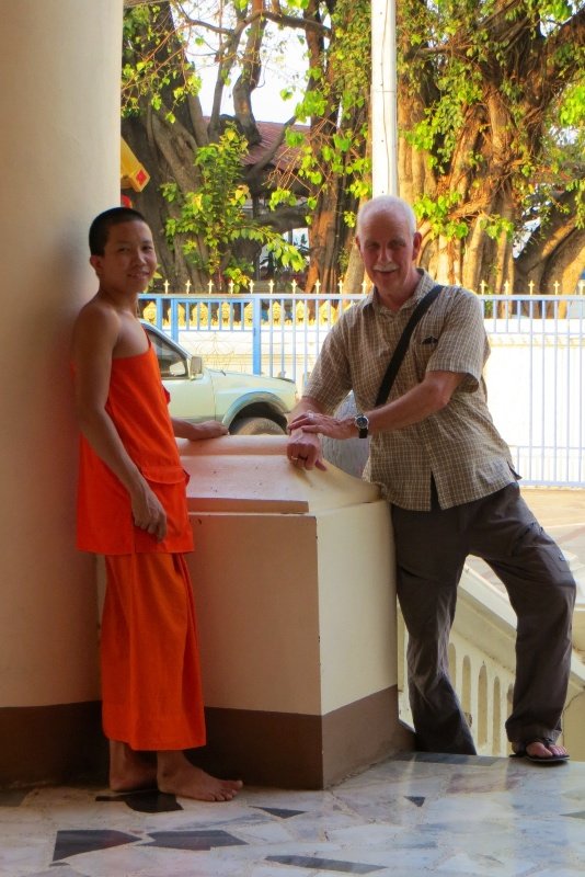 Jerry and a young monk chatting together at a temple in Mukdahan