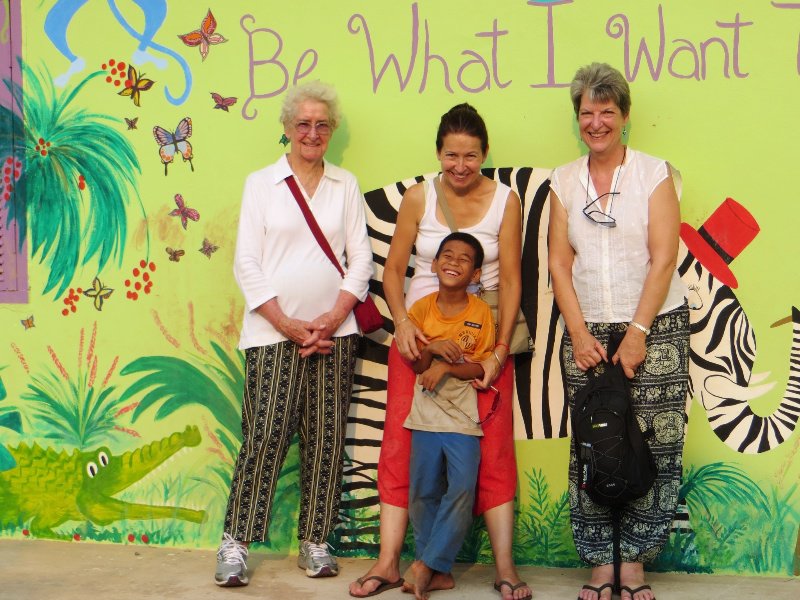Mum, Suzie and Ginny (plus a student) in front of one of the murals at ABC + RICE